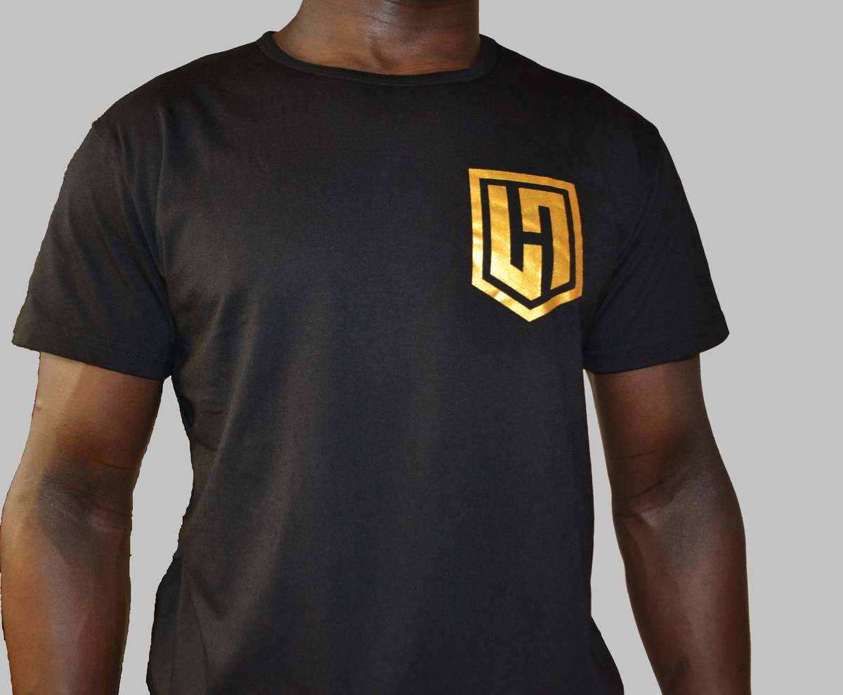 Hustle Passion Knowledge T-shirt in black, front view with gold H shield logo on the chest